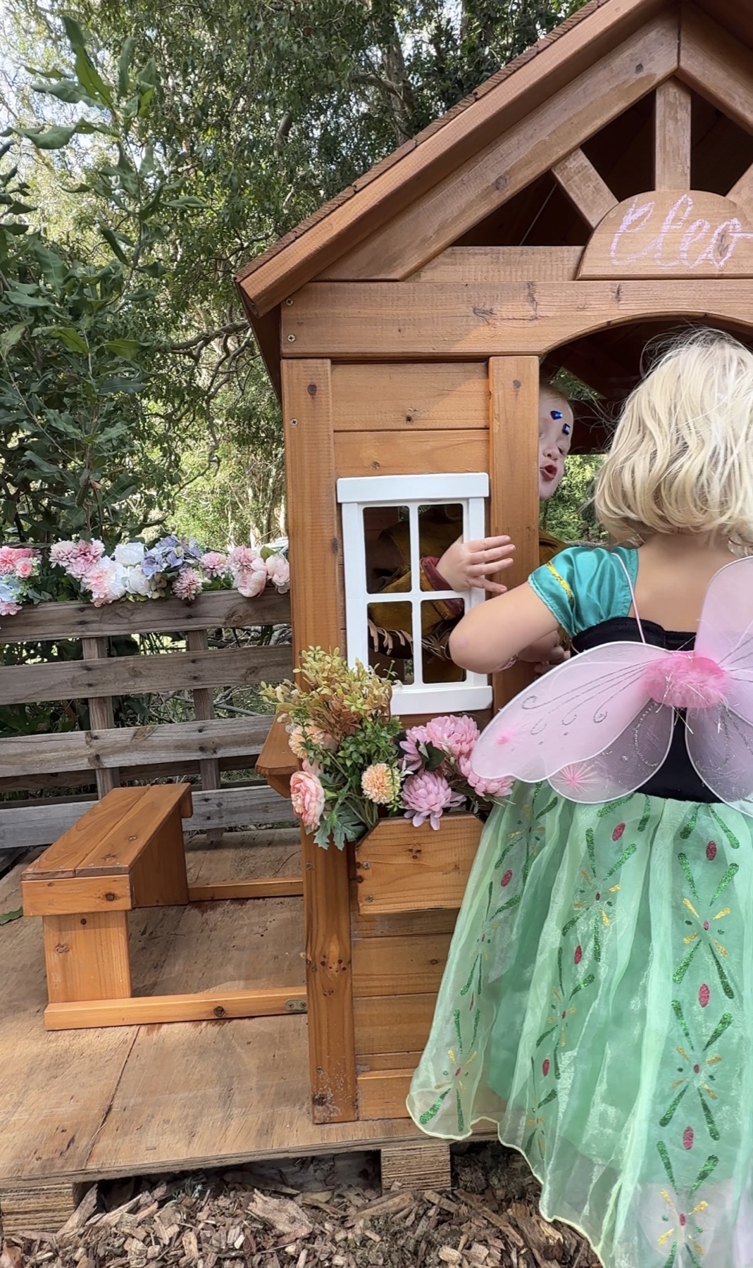 Children enjoying dress-up play together in the Little Oaks woodland